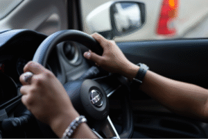 A shot of a driver holding the steering wheel for the media analytics report about Nissan dominating the media coverage in the Philippines.