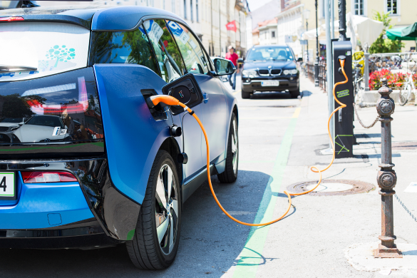 BMW car charging on the side of the street for the media analytics report how BMW takes the lead among luxury electric vehicle makers in the Philippines.