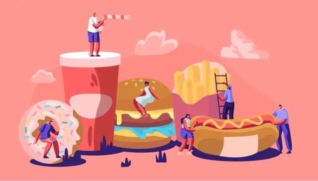 The image is a whimsical and colorful illustration featuring oversized fast-food items, including a large soft drink, a donut with sprinkles, a hamburger, french fries, and a hot dog. Several small human figures interact with these giant food items: one person stands on top of the soft drink holding a straw, another walks through the hole of the donut, two people are climbing on the hamburger, another person is climbing a ladder leaning on the french fries, and two people are engaging with the hot dog. The background is a soft pink color with light clouds, giving the scene a playful and surreal atmosphere, likely representing themes related to fast food culture, indulgence, or a creative take on the fast food industry.
