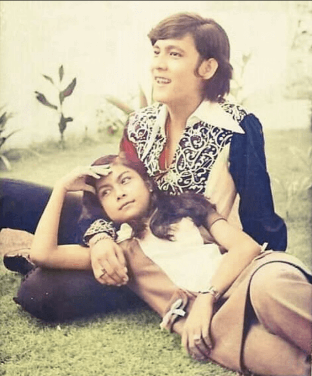 Vintage Filipino love teams photo of Nora Aunor and Tirso Cruz III from the 1970s, relaxing together outdoors in retro patterned and casual clothing